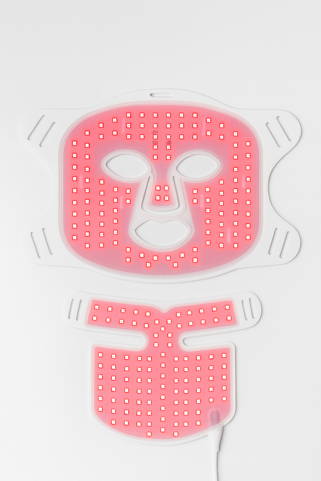 Red LED face mask with a neutral expression on a white background