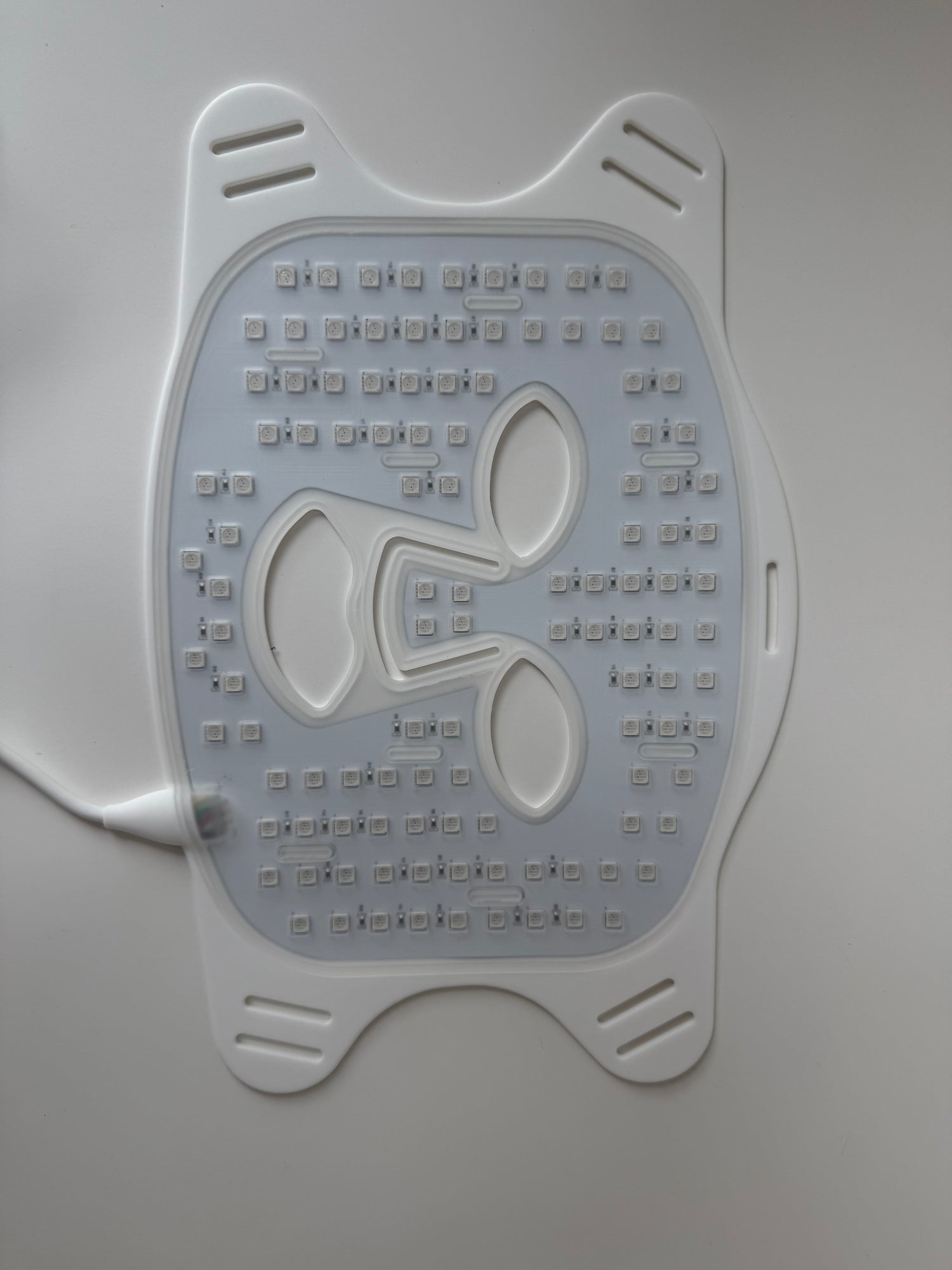 Backside of red light therapy mask showing dense LED light array for skin rejuvenation